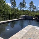 dark color swimming pool with waterfall